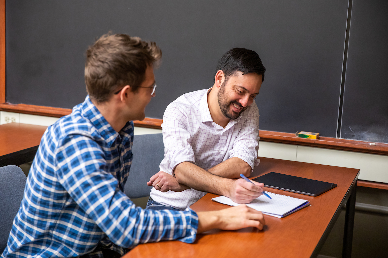 two people reviewing a document in classroom